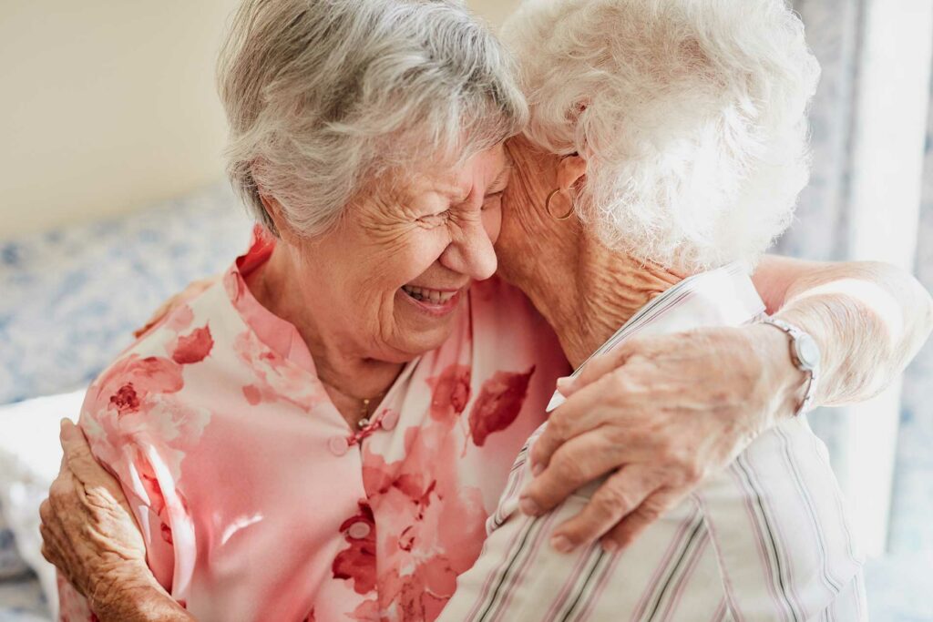 Happy, hug and senior woman friendship