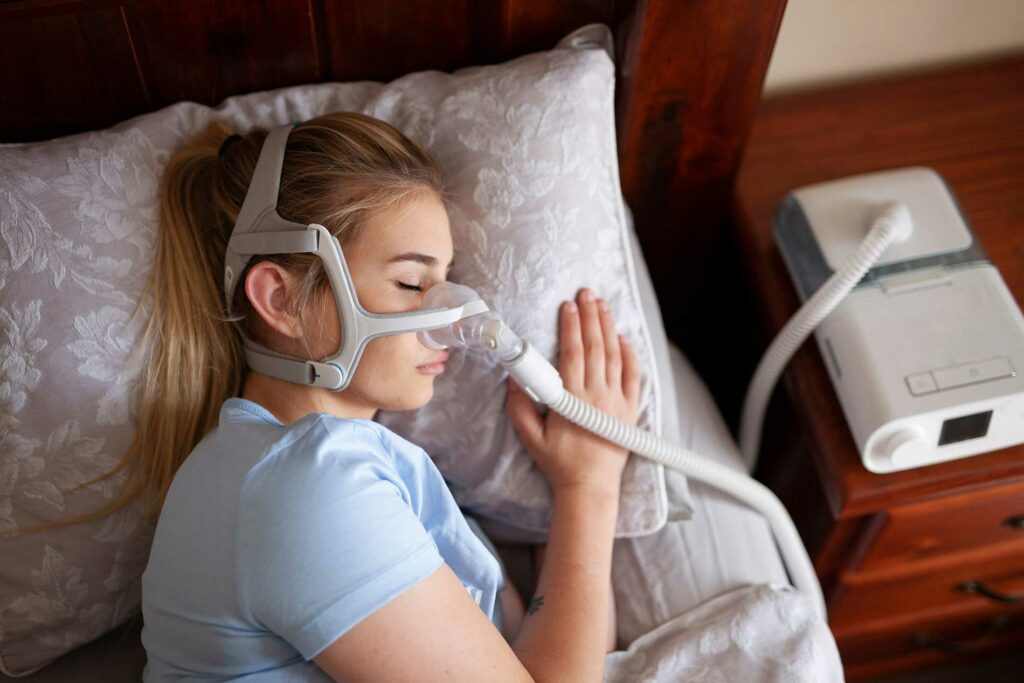 girl sleeping with a machine to monitor her breathing