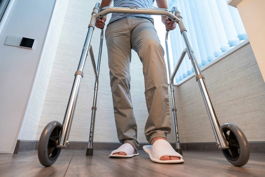 person using a walker to start to walk again