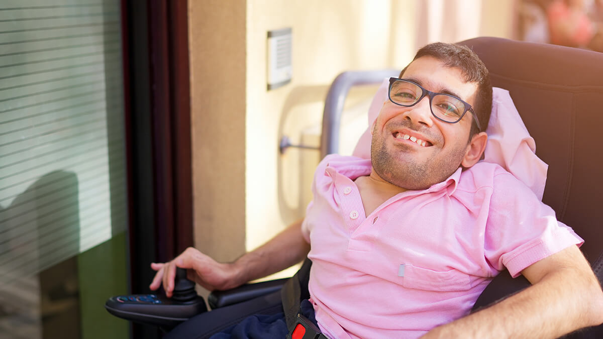 Smiling man in power wheelchair